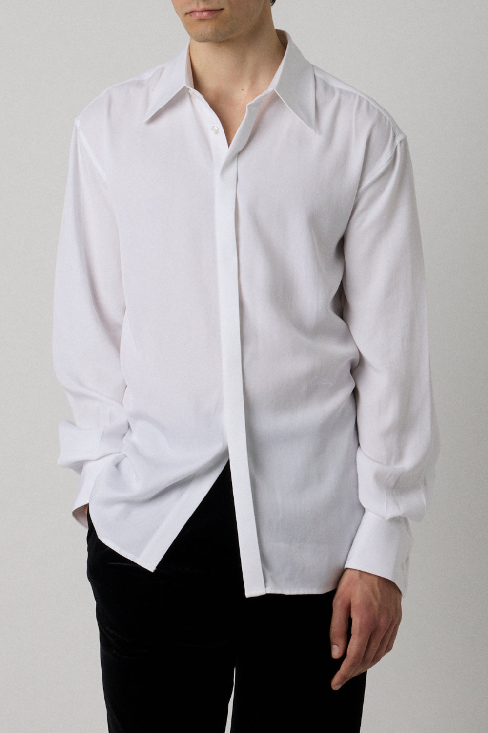 White dress shirt with a unique collar design worn by a person on a plain background