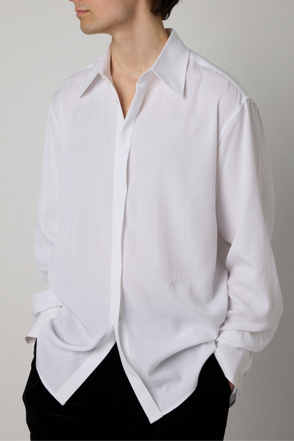 White shirt worn by a person on a plain background