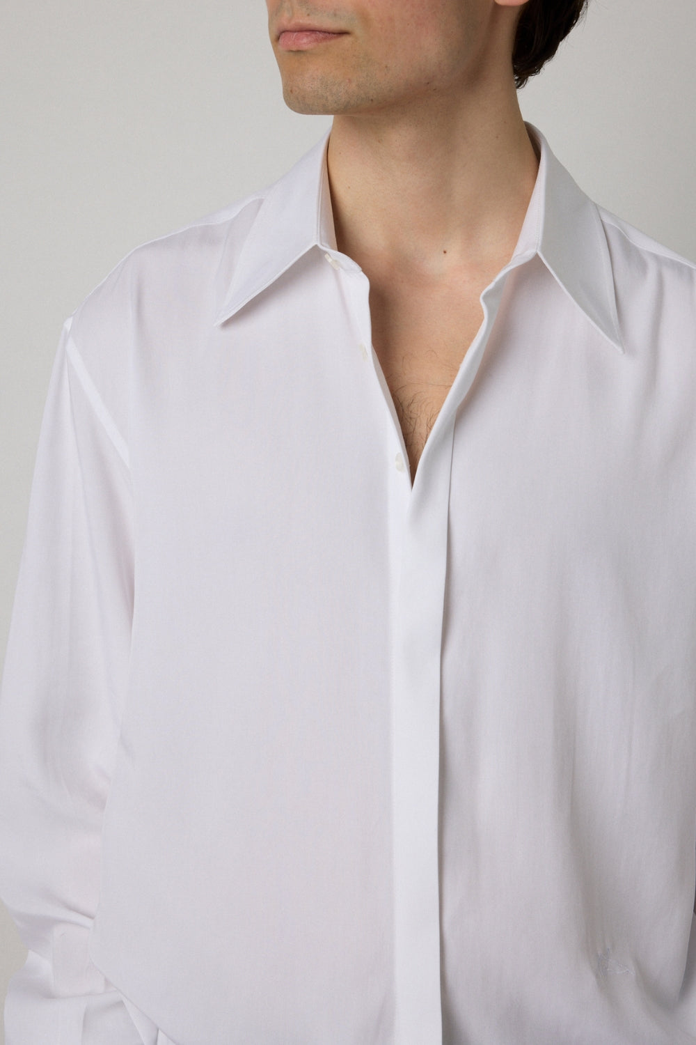 White shirt worn by a person against a neutral background